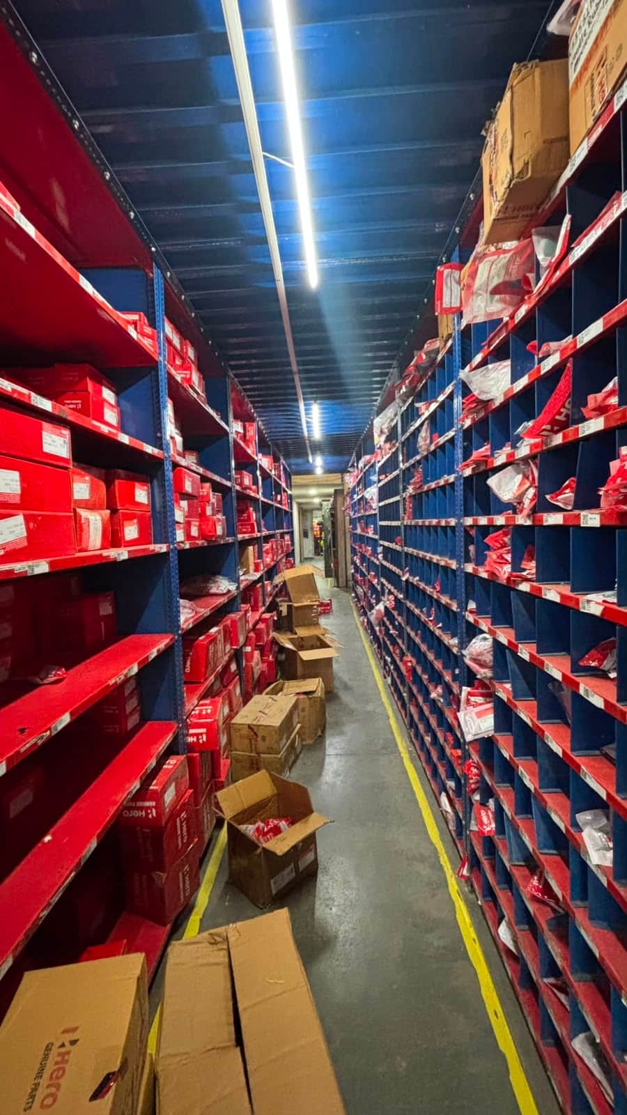 Dispatch aisle with open cartons being picked for a spare parts export order