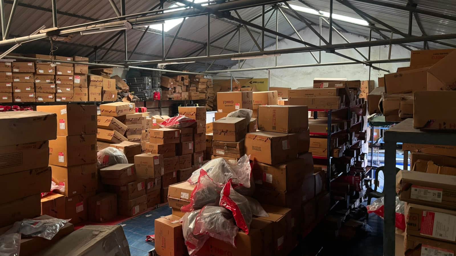 Raznova Exports warehouse in Pune with two-wheeler spare parts cartons staged for export dispatch